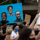 Protesters carry a painting of Ahmaud Arbery, left, Breonna Taylor and George Floyd while marching on June 5, 2020 in Louisville, Ky.
